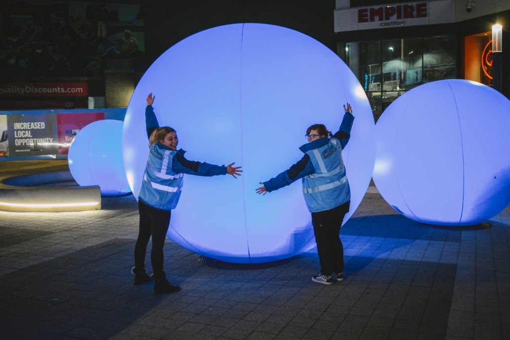 Basildon, Shine ON! December 2023. Creative Basildon staff interacting with the blue spheres.